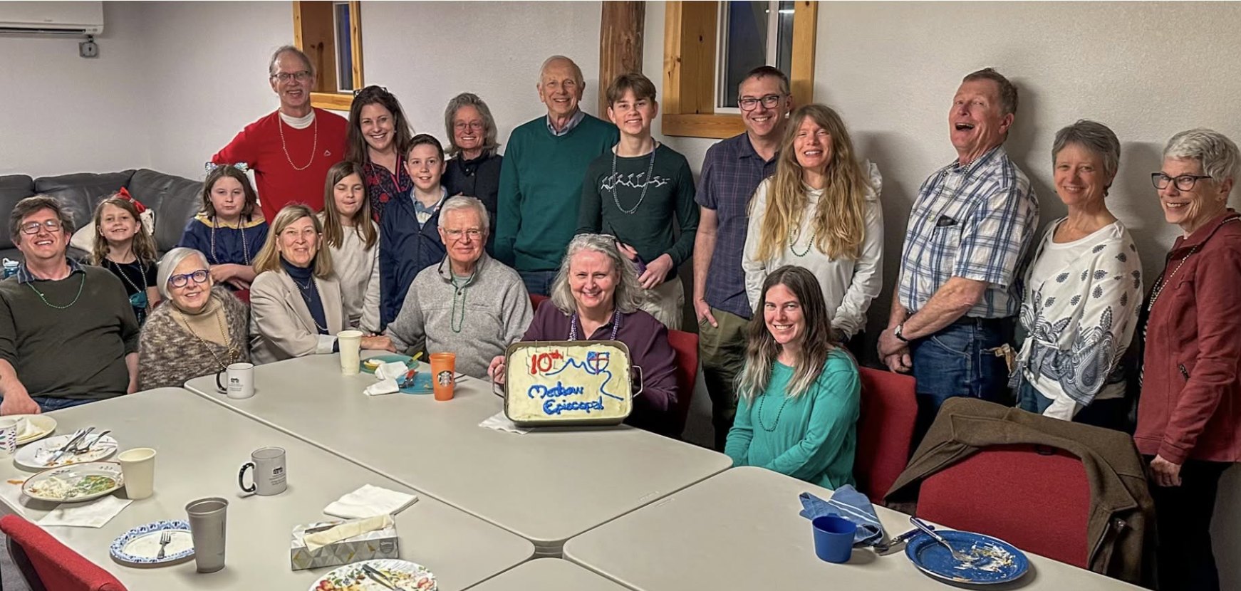 The fellowship gathered around a cake celebrating ten years of Methow Episcopal